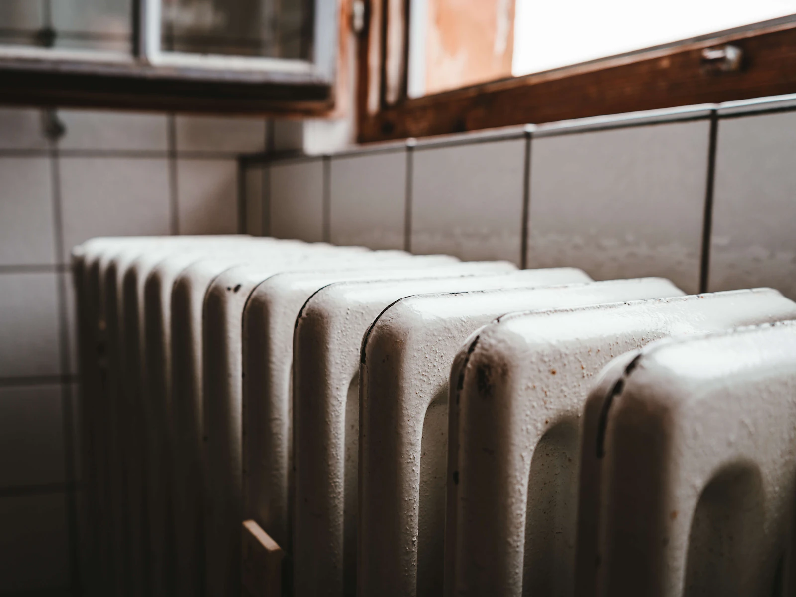 An old cast-iron radiator under a window