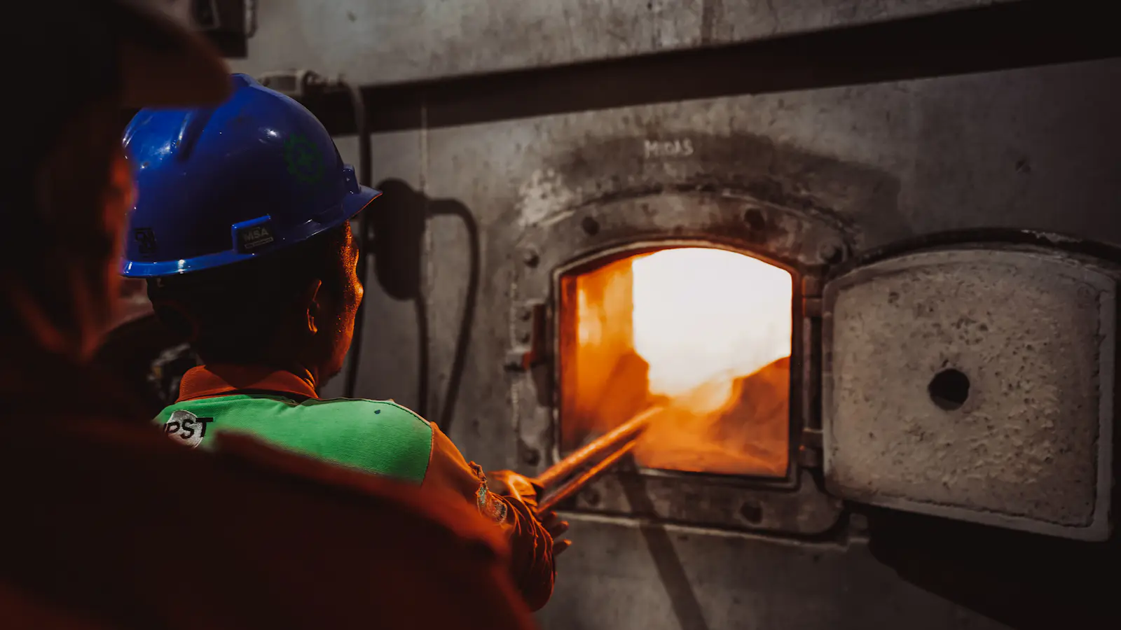 A technician looking into a boiler flame window