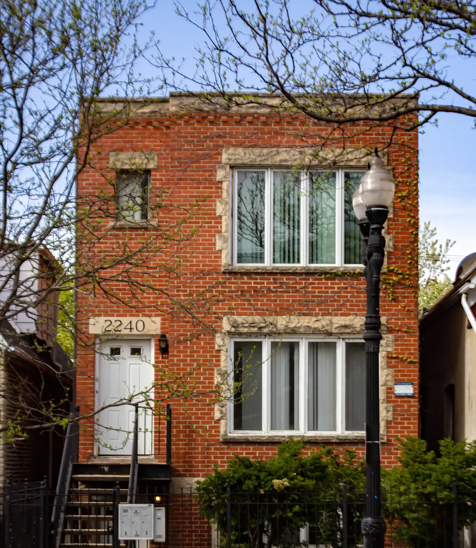 A red brick Chicago building with a white front door