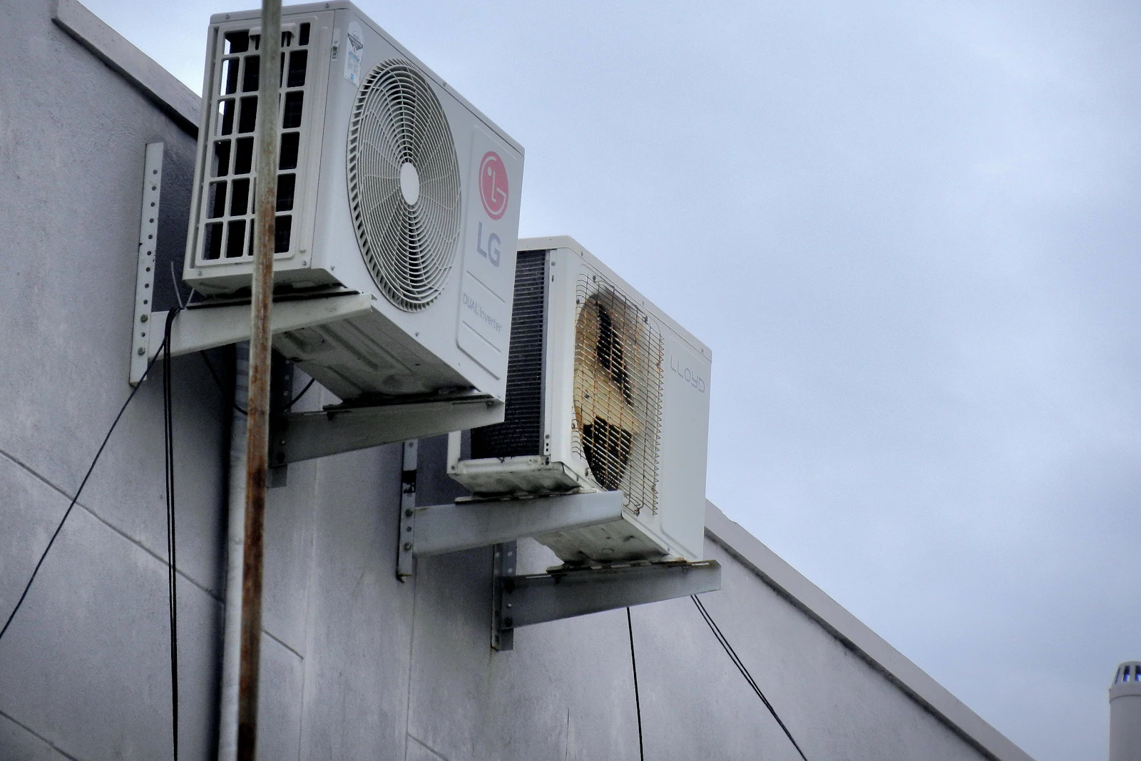Two air conditioner units mounted on the side of a building