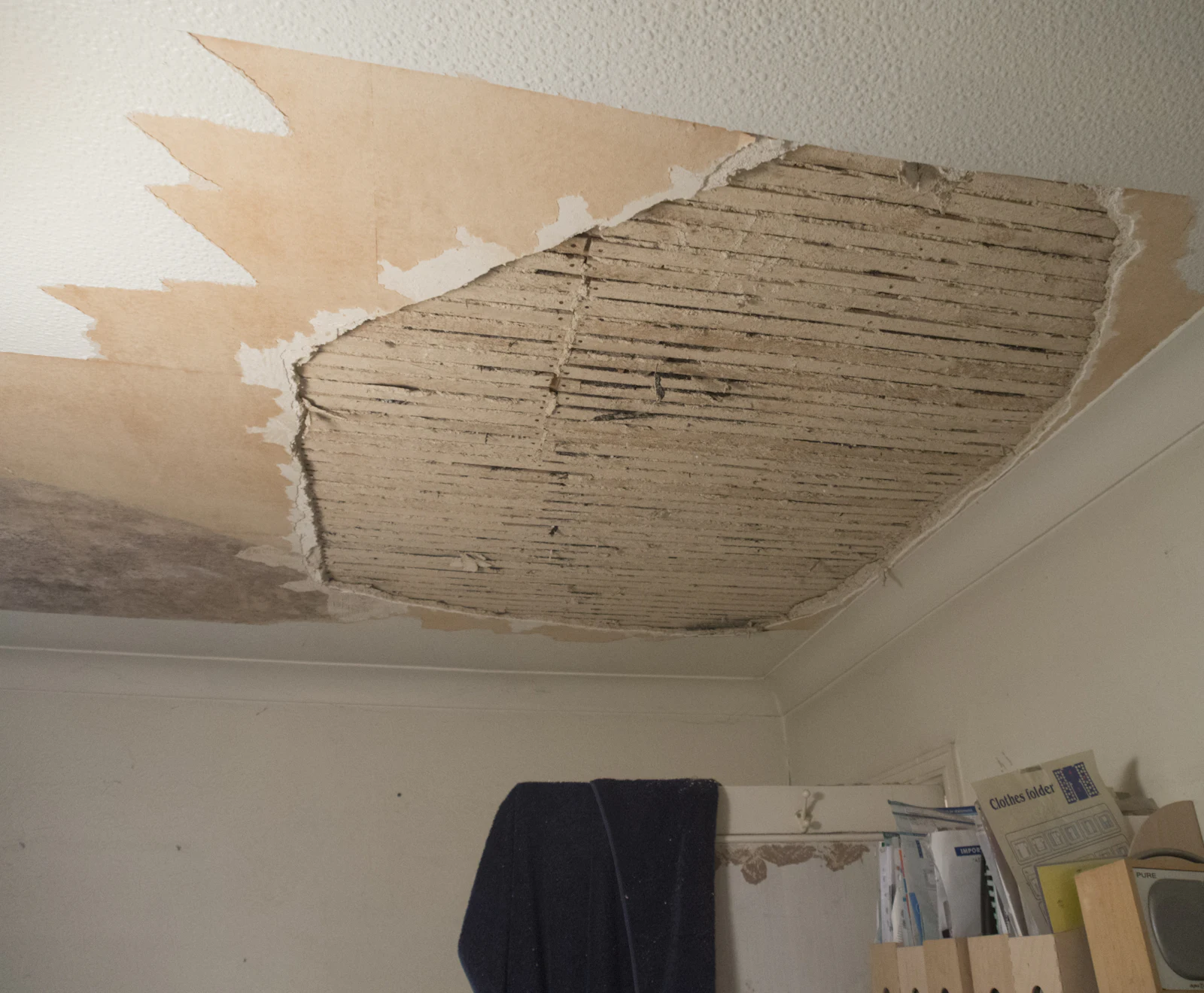 A room with a damaged ceiling opened up for repair