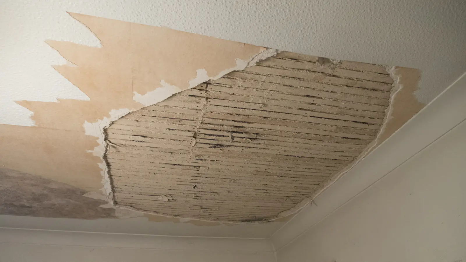 A room with a damaged ceiling opened up for repair